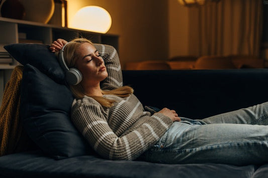 Woman listening to brown noise to sleep