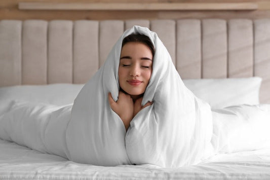 Girl under cool bed sheets