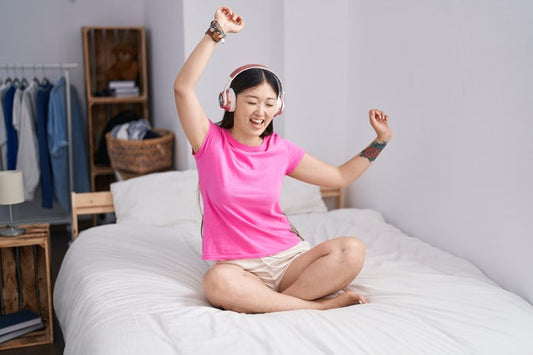 Girl  listening to music in a dorm