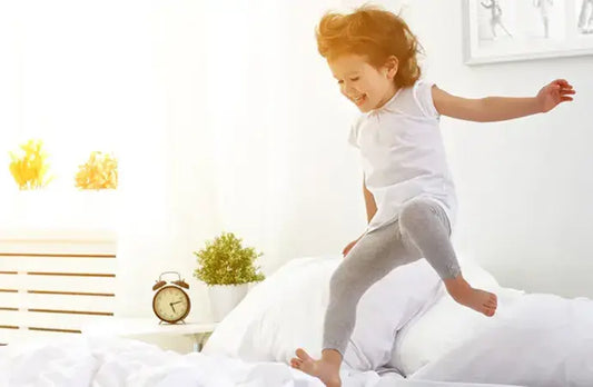 A child jumping on the bed