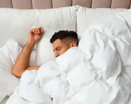 Man sleeping in a box stitched comforter